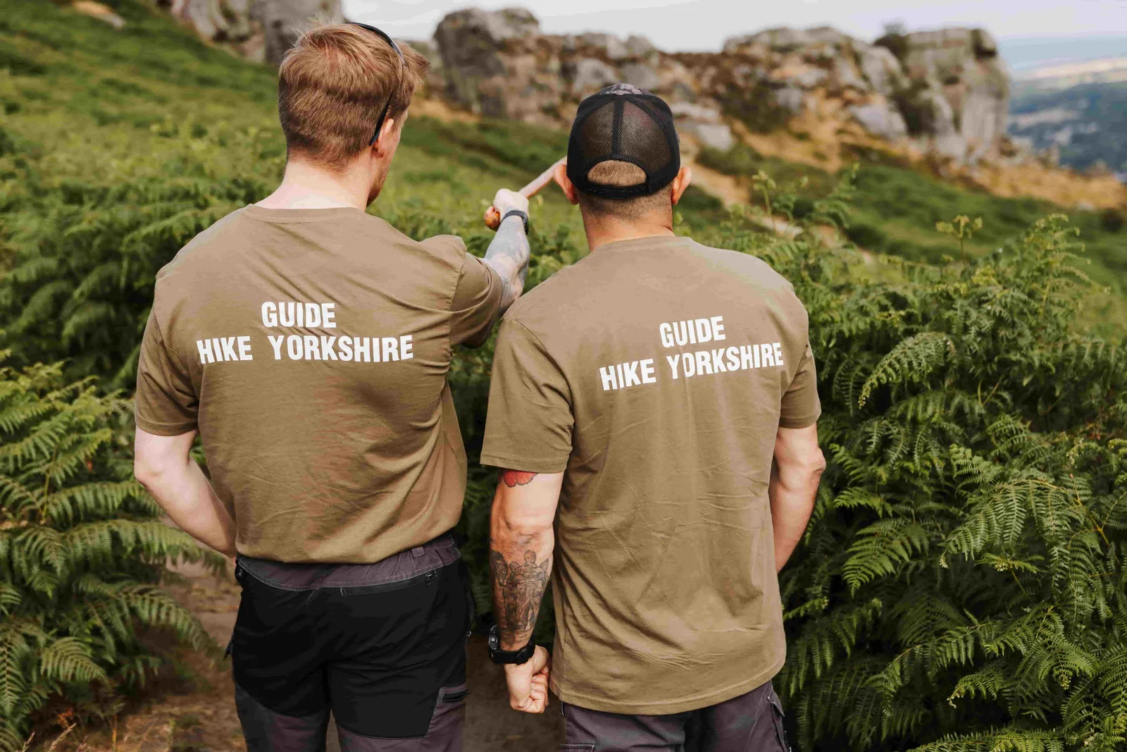 Two Hike Yorkshire instructors orientating a group on the moor
