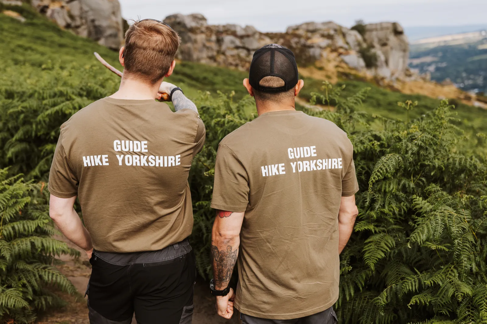 Hike Yorkshire guides pointing out the Cow and Calf rocks on Ilkley Moor